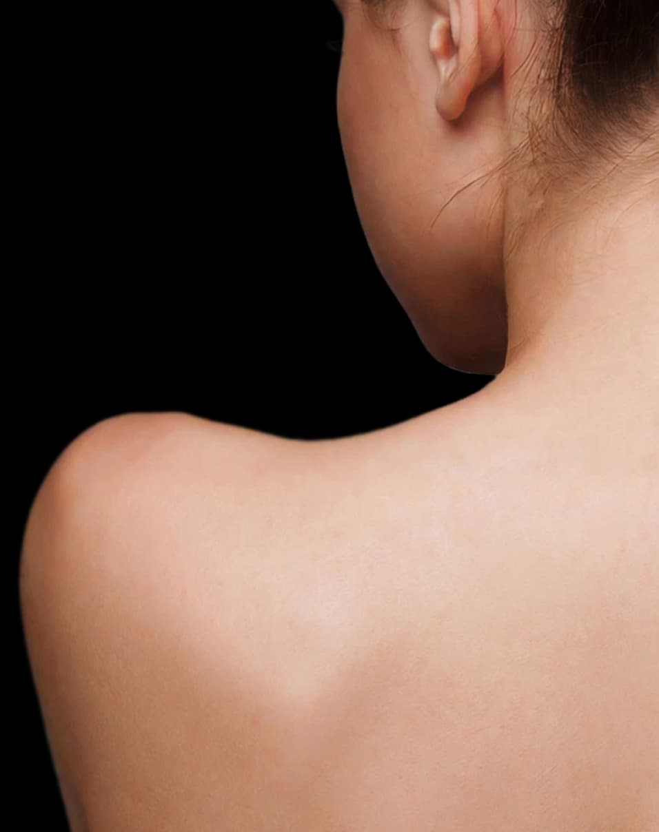Woman facing away from the camera with a bare shoulder